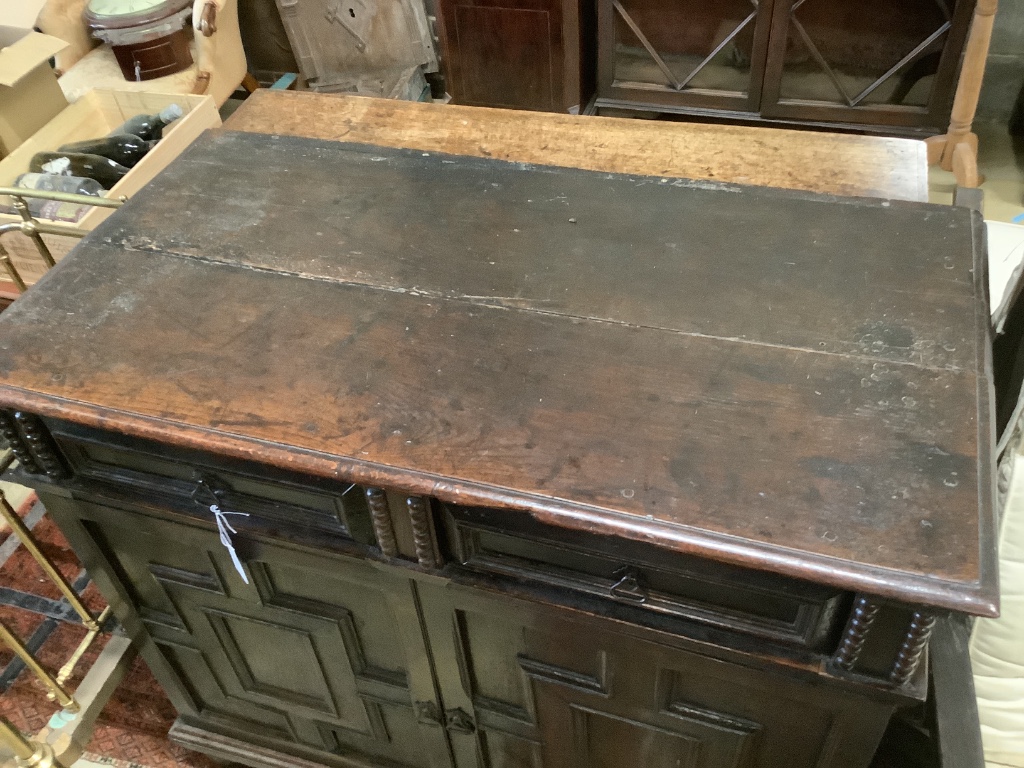 An early 18th century and later oak cupboard, with two frieze drawers, width 115cm